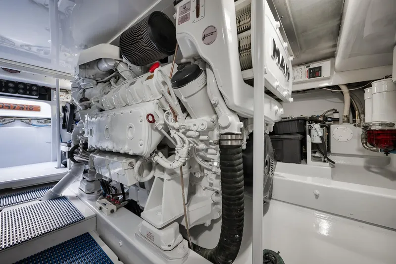 Slide: The Image of Engine room of a 1997 Garlington 61 yacht, featuring a clean, organized layout. - 74