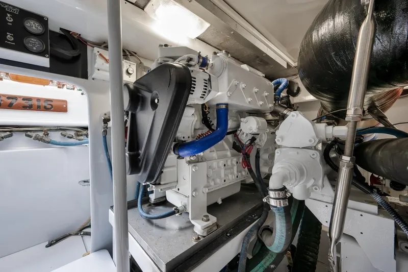 Slide: The Image of Engine room of a 1997 Garlington 61 boat, showcasing mechanical components and wiring. - 75