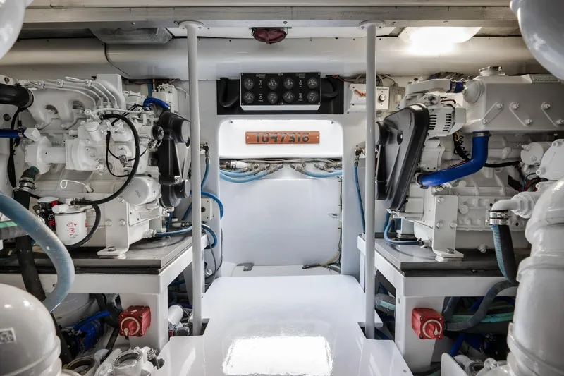 Slide: The Image of Engine room of a 1997 Garlington 61 yacht, showcasing dual engines and control panel. - 77