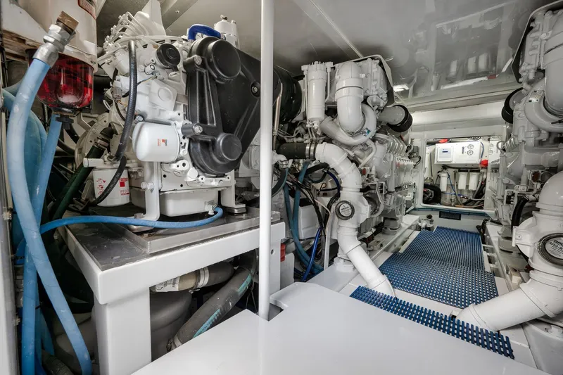 Slide: The Image of Engine room of a 1997 Garlington 61 yacht, featuring complex machinery and piping. - 78