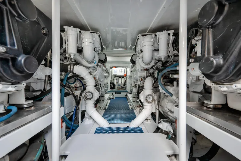 Slide: The Image of Engine room of a 1997 Garlington 61 yacht, showcasing complex machinery and piping. - 79