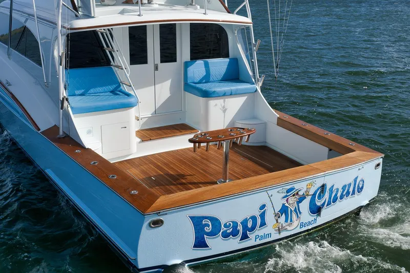 Slide: The Image of 1997 Garlington 61 yacht "Papi Chulo" with blue seating, cruising in open water. - 8
