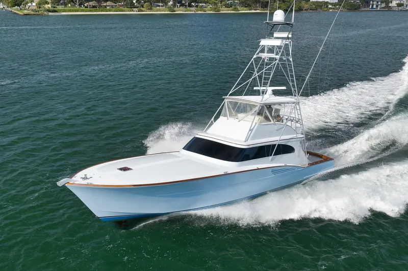 Slide: The Image of 1997 Garlington 61 yacht cruising on open water, showcasing sleek design and powerful performance. - 88