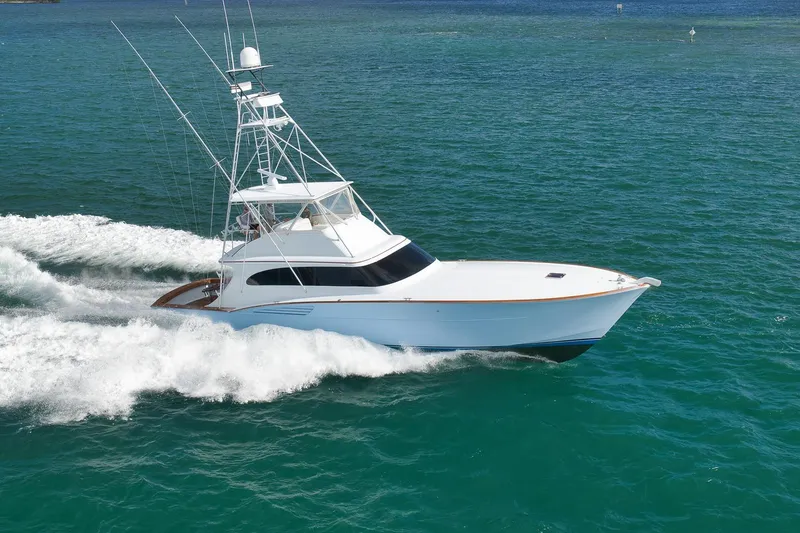 Slide: The Image of 1997 Garlington 61 yacht cruising on open water, showcasing sleek design and powerful performance. - 94