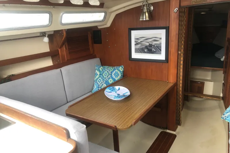 Slide: The Image of Interior of 1986 Catalina 30 MkII sailboat with cozy dining area and nautical decor. - 3
