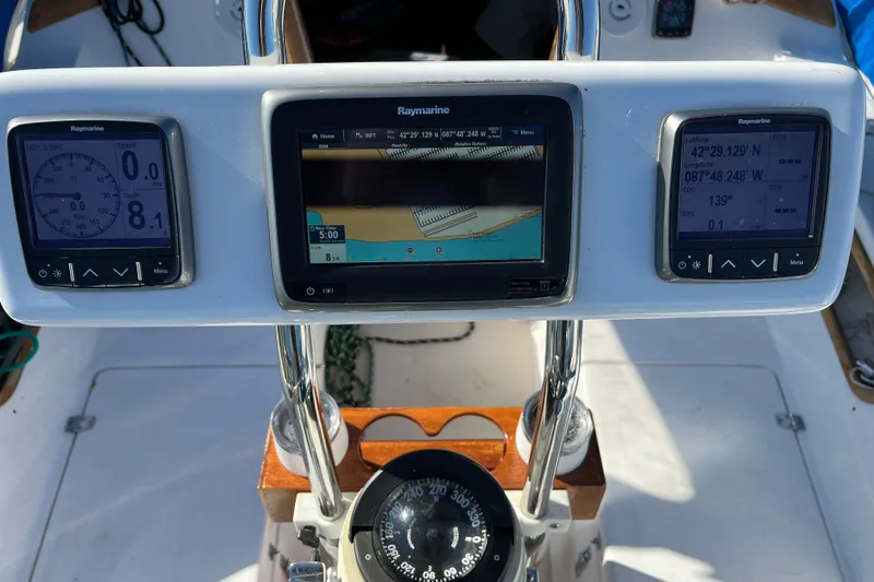 Slide: The Image of Catalina 30 MkII 1986 sailboat cockpit with Raymarine navigation displays and compass. - 5
