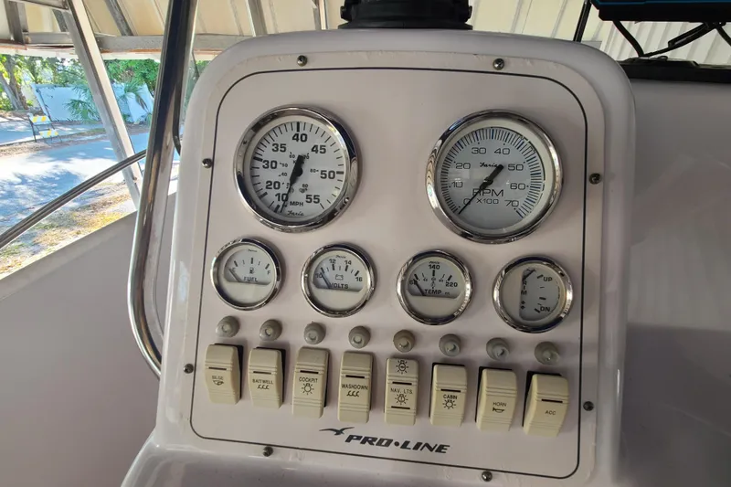 Slide: The Image of Dashboard of a 2002 Pro-Line 22 Sport boat with gauges and switches. - 10