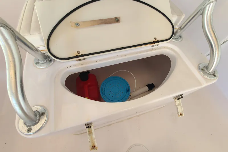 Slide: The Image of Storage compartment on a 2002 Pro-Line 22 Sport boat with red fuel container. - 14