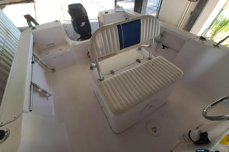 Slide: The Image of 2002 Pro-Line 22 Sport boat interior with seating and Mercury outboard motor. - 15