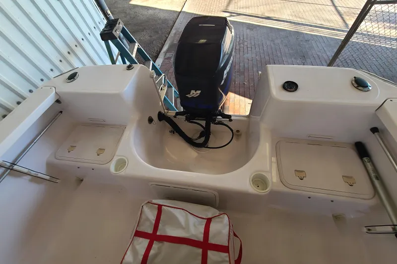 Slide: The Image of 2002 Pro-Line 22 Sport boat interior with motor and storage compartments. - 17