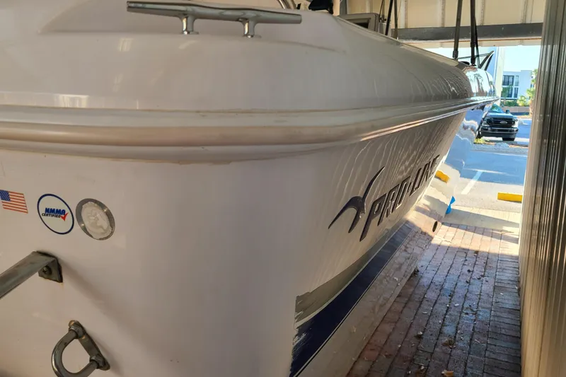 Slide: The Image of 2002 Pro-Line 22 Sport boat in storage, side view with logo and certifications visible. - 23