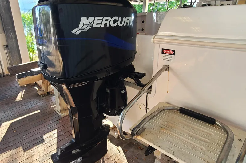 Slide: The Image of 2002 Pro-Line 22 Sport boat with Mercury outboard motor, docked on brick surface. - 24