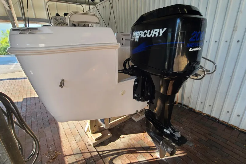 Slide: The Image of 2002 Pro-Line 22 Sport boat with Mercury 200 Saltwater outboard engine in storage. - 25