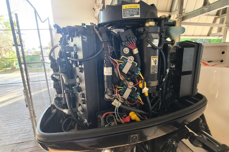 Slide: The Image of 2002 Pro-Line 22 Sport boat engine with exposed wiring and components. - 27