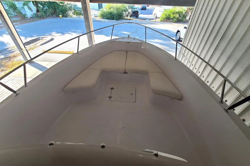 Slide: The Image of 2002 Pro-Line 22 Sport boat interior with cushioned seating and metal railings. - 3