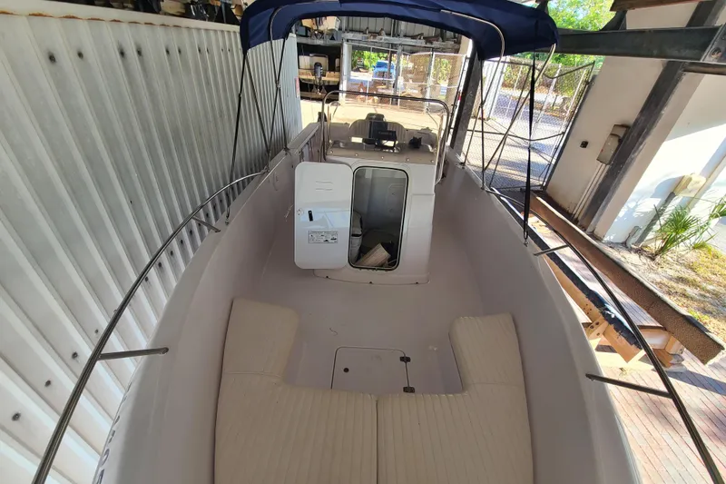 Slide: The Image of 2002 Pro-Line 22 Sport boat interior with seating and canopy in storage. - 4