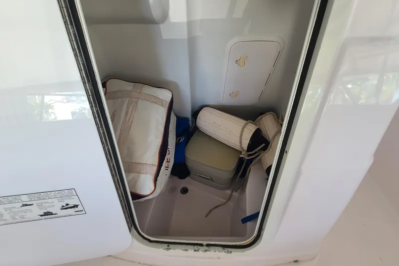 Slide: The Image of Storage compartment in a 2002 Pro-Line 22 Sport boat with gear and equipment. - 6