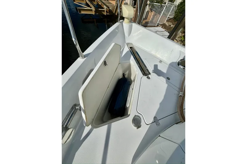 Slide: The Image of 2004 Marquis 59 yacht deck with open storage compartment. - 10