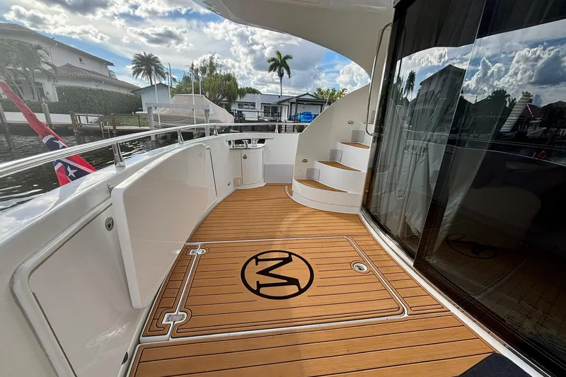 Slide: The Image of Luxurious 2004 Marquis 59 yacht deck with wooden flooring and elegant design. - 12