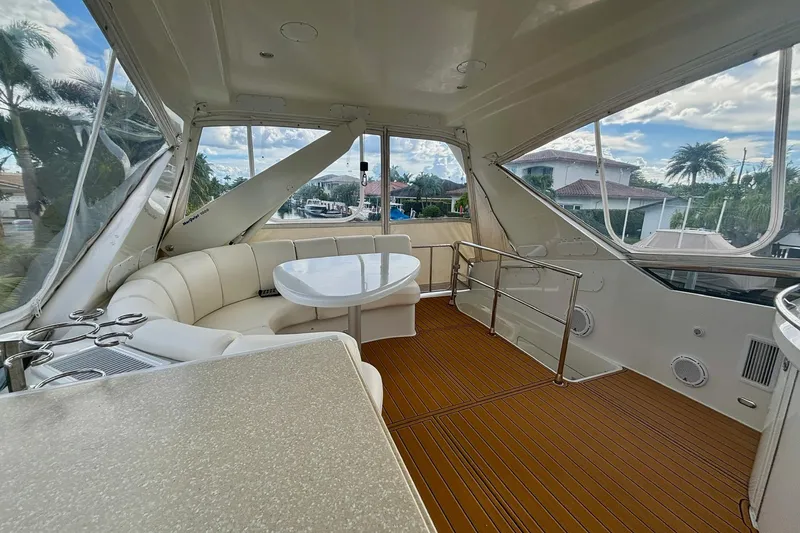 Slide: The Image of Luxurious 2004 Marquis 59 yacht interior with elegant seating and scenic views. - 15