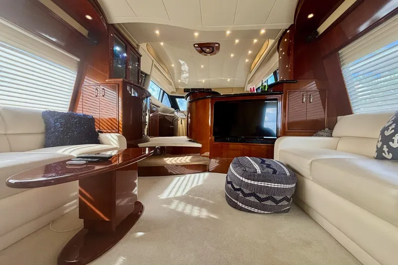 Slide: The Image of Luxurious interior of a 2004 Marquis 59 yacht with elegant wood finishes and plush seating. - 18