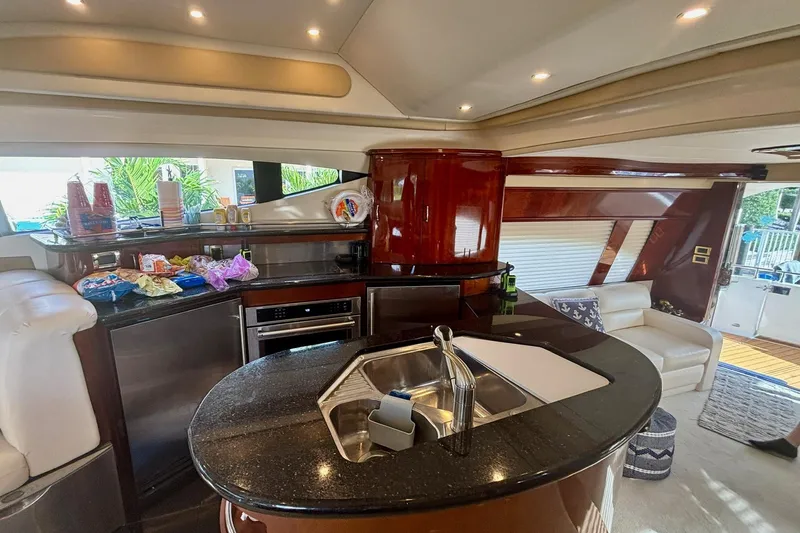 Slide: The Image of Luxurious 2004 Marquis 59 yacht interior with modern kitchen and seating area. - 21