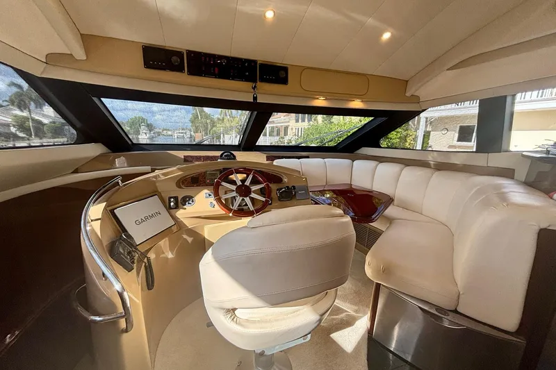 Slide: The Image of Luxurious 2004 Marquis 59 yacht interior with plush seating and modern navigation equipment. - 23