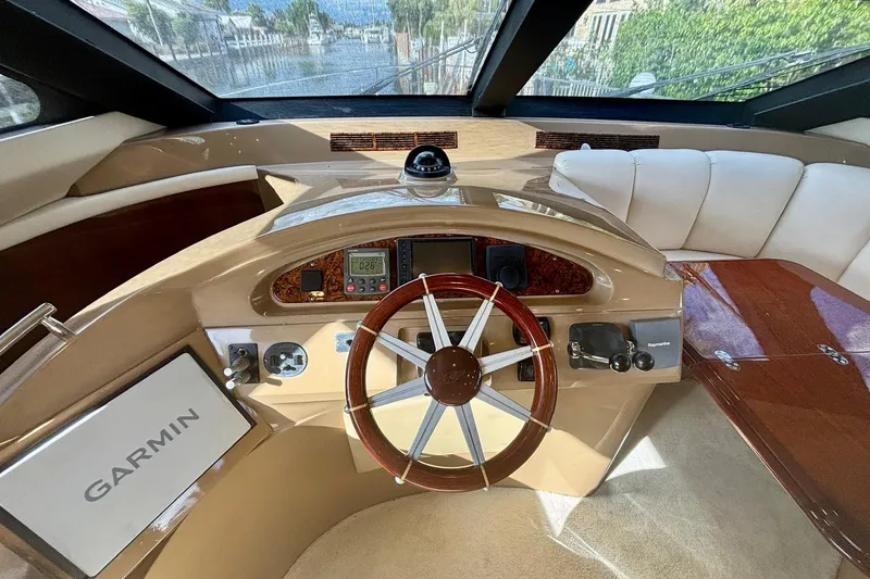 Slide: The Image of Luxurious 2004 Marquis 59 yacht helm with Garmin navigation and elegant seating. - 24
