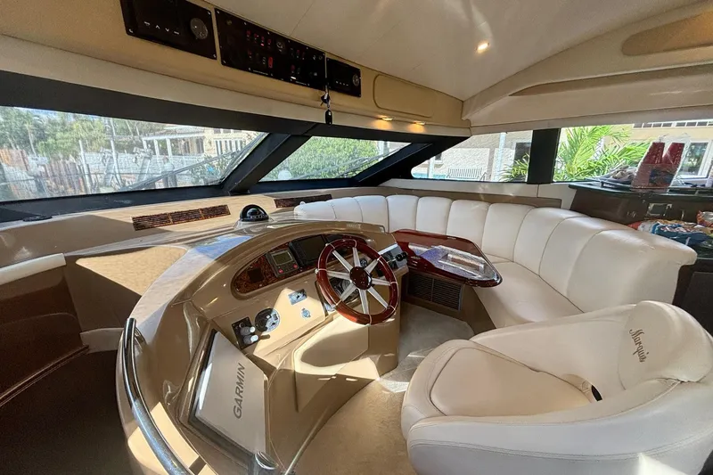 Slide: The Image of Luxurious 2004 Marquis 59 yacht interior with plush seating and modern navigation controls. - 25