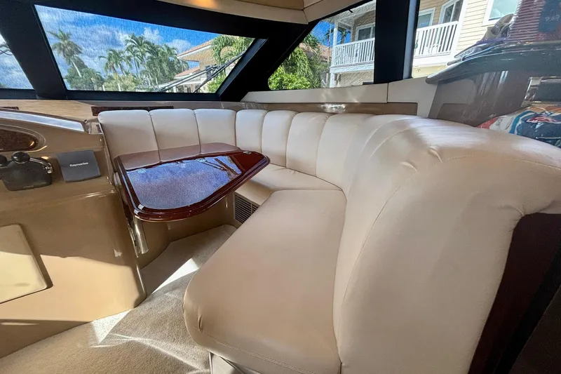 Slide: The Image of Luxurious interior of a 2004 Marquis 59 yacht with plush seating and elegant wood table. - 28