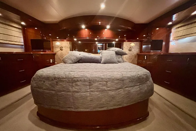Slide: The Image of Luxurious 2004 Marquis 59 yacht bedroom with elegant wood finishes and plush bedding. - 36
