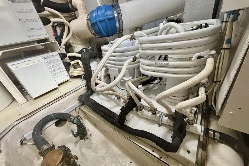Slide: The Image of Engine room of a 2004 Marquis 59 yacht with coiled hoses and equipment. - 39