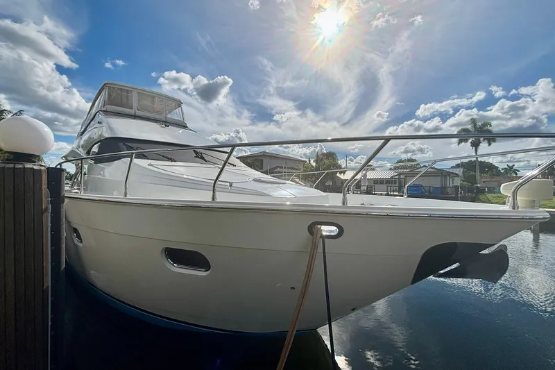 Slide: The Image of Luxury 2004 Marquis 59 yacht docked under a bright, sunny sky. - 4