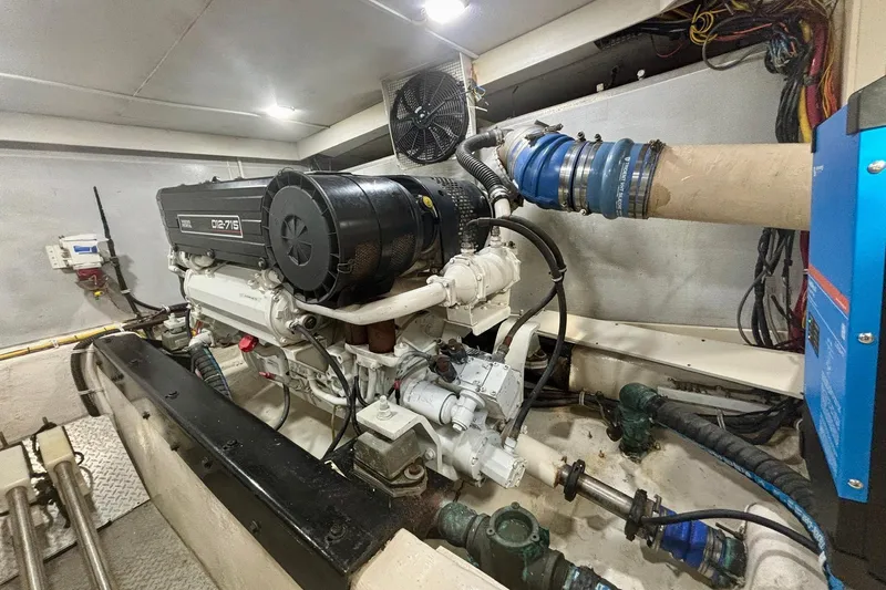 Slide: The Image of Engine room of a 2004 Marquis 59 yacht, featuring a powerful D12-715 engine. - 40