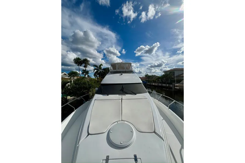Slide: The Image of 2004 Marquis 59 yacht on a sunny day with palm trees and blue sky. - 5