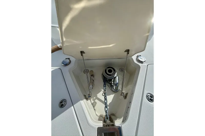 Slide: The Image of Anchor compartment of 2004 Marquis 59 yacht with open hatch and chain. - 9