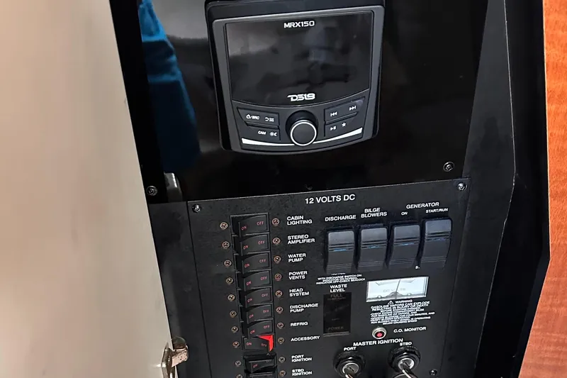 Slide: The Image of Control panel of a 2005 Sea Ray 320 Sundancer boat with switches and stereo system. - 14