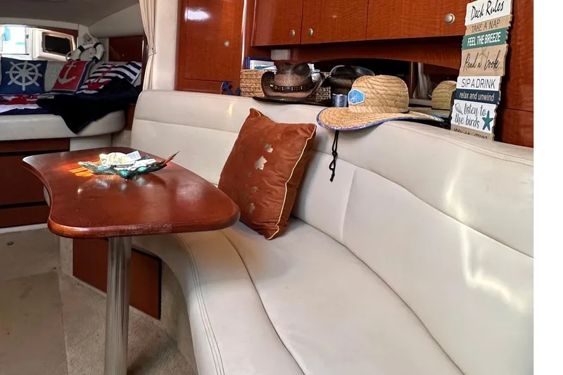 Slide: The Image of Interior of 2005 Sea Ray 320 Sundancer with cozy seating and nautical decor. - 8