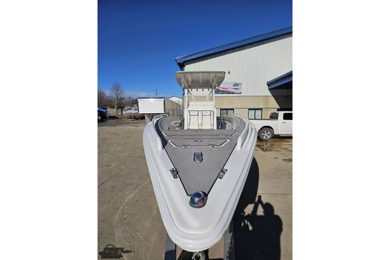 Slide: The Image of 2014 Concept 36' CC boat with vibrant green and blue design, parked outside a building. - 15