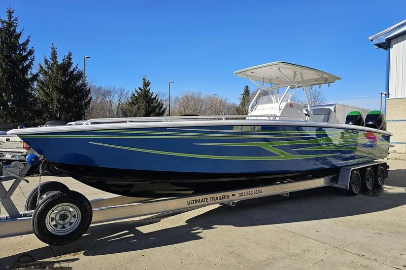 Slide: The Image of 2014 Concept 36' CC boat with blue and green design on a trailer at Grand Sport Center. - 18
