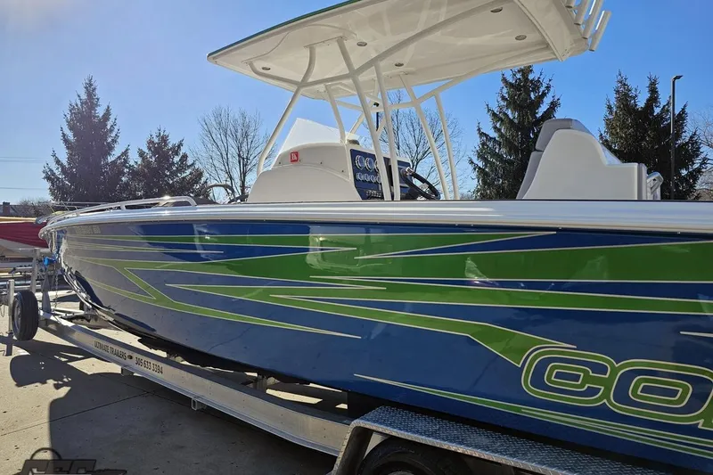 Slide: The Image of 2014 Concept 36' CC boat on trailer, blue and green design, parked outdoors. - 23