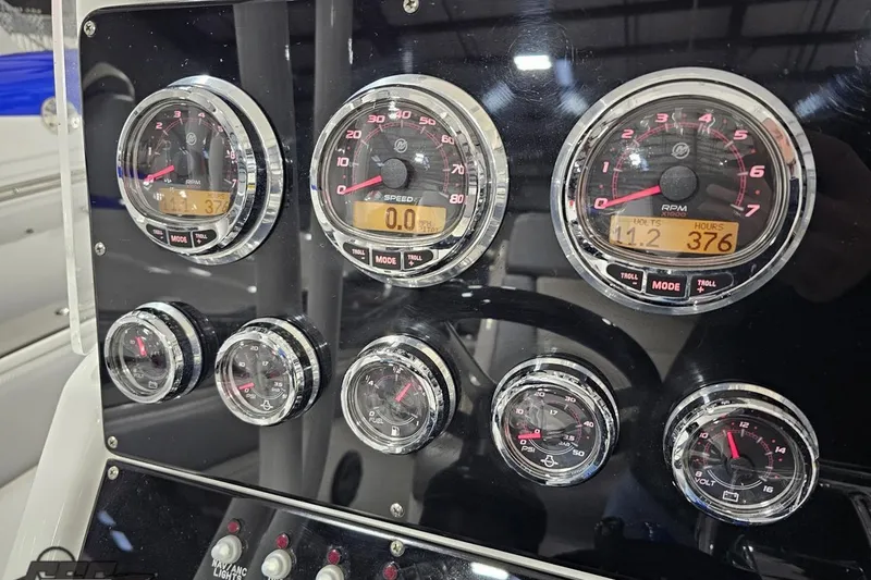 Slide: The Image of 2014 Concept 36' CC boat with vibrant blue and green design on trailer. - 31