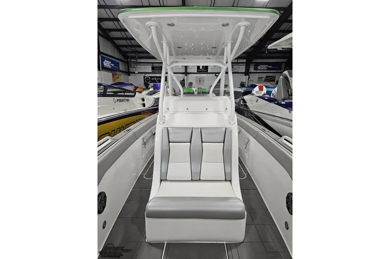 Slide: The Image of Twin Mercury outboard engines on a 2014 Concept 36' CC boat, under clear blue sky. - 37