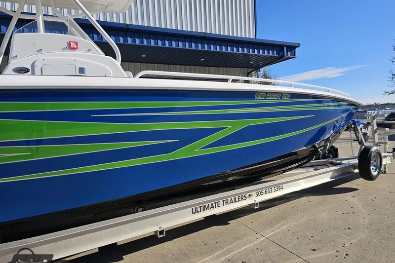 Slide: The Image of 2014 Concept 36' CC boat with blue and green design on a trailer. - 5