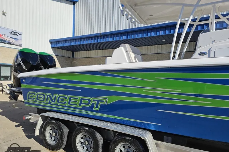 Slide: The Image of 2014 Concept 36' CC boat with vibrant blue and green design on a trailer. - 6