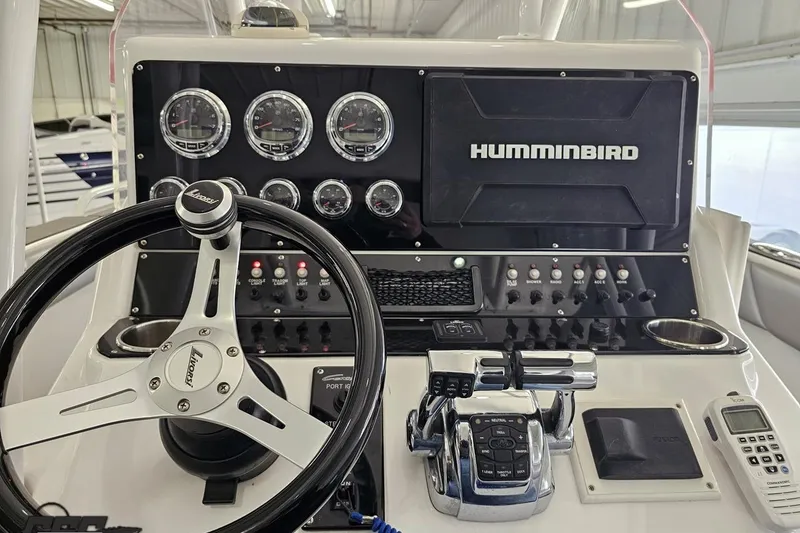 Slide: The Image of Control panel of a 2014 Concept 36' CC boat with Humminbird display and steering wheel. - 64