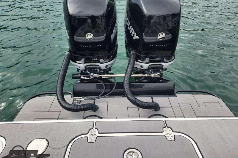 Slide: The Image of Twin Mercury outboard engines on 2014 Concept 36' CC boat, docked on water. - 79