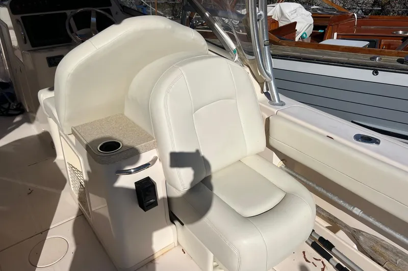 Slide: The Image of 2011 Grady-White Freedom 307 boat interior with white seating and cup holder. - 10