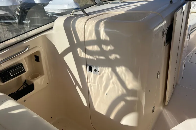 Slide: The Image of 2011 Grady-White Freedom 307 boat interior with radio and storage compartment. - 3