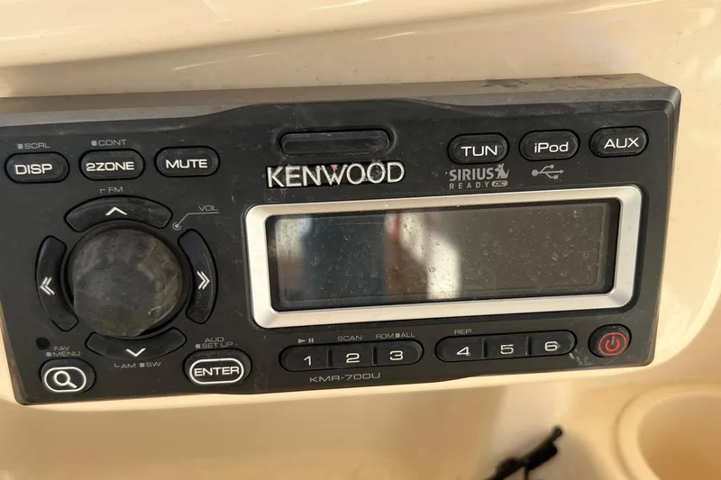 Slide: The Image of Kenwood KMR-700U stereo system on 2011 Grady-White Freedom 307 boat dashboard. - 7